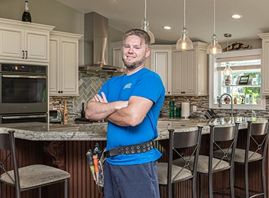 Electrician standing in beautiful modern kitchen